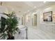 A luxurious, white-marble bathroom with an elegant soaking tub and a separate glass-enclosed shower stall at 801 Brightwaters Ne Blvd, St Petersburg, FL 33704