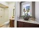 Bathroom with glass shower, toilet, and vanity with granite countertop and decorative flower arrangement at 801 Brightwaters Ne Blvd, St Petersburg, FL 33704