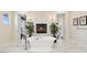 A bright primary bathroom with a soaking tub, white marble floors, and a fireplace with an ornate tile surround at 801 Brightwaters Ne Blvd, St Petersburg, FL 33704