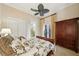 Bedroom featuring a decorative bed, dark wood cabinet, and neutral decor at 801 Brightwaters Ne Blvd, St Petersburg, FL 33704