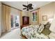 Bright bedroom with doors to outside, dark wood accents, and floral bedding at 801 Brightwaters Ne Blvd, St Petersburg, FL 33704