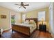 Bedroom features a queen bed, ceiling fan, and a private balcony that has plenty of light at 801 Brightwaters Ne Blvd, St Petersburg, FL 33704