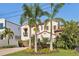 Landscaped Mediterranean-style home with a garden, a brick driveway, and a two-car garage at 801 Brightwaters Ne Blvd, St Petersburg, FL 33704