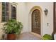 Arched doorway and stone facade with lush plants in the entryway at 801 Brightwaters Ne Blvd, St Petersburg, FL 33704