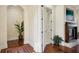 Hallway with hardwood floors, white trim, and a fireplace in the background at 801 Brightwaters Ne Blvd, St Petersburg, FL 33704