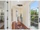 Hallway with dark wood floors, a chandelier, and doors to a balcony at 801 Brightwaters Ne Blvd, St Petersburg, FL 33704