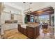 Kitchen with island seating, a farmhouse sink, and views into the living area at 801 Brightwaters Ne Blvd, St Petersburg, FL 33704