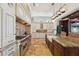 Professional-grade kitchen with an island, custom hood, and plenty of storage space at 801 Brightwaters Ne Blvd, St Petersburg, FL 33704