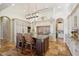 Gourmet kitchen featuring an island with seating, high-end appliances, and custom cabinetry at 801 Brightwaters Ne Blvd, St Petersburg, FL 33704
