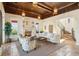 Comfortable living room with fireplace, coffered ceiling, and tile floors at 801 Brightwaters Ne Blvd, St Petersburg, FL 33704