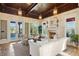 Elegant living room with coffered wood ceiling, fireplace, and access to the outdoor space at 801 Brightwaters Ne Blvd, St Petersburg, FL 33704