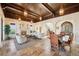 Open living room with fireplace, dining area, and staircase at 801 Brightwaters Ne Blvd, St Petersburg, FL 33704