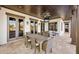 Inviting outdoor patio with dining area, ceiling fan, and views of waterfront and canal at 801 Brightwaters Ne Blvd, St Petersburg, FL 33704