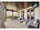 Outdoor patio with tile floors, covered ceiling, fan, a dining table, and sitting area with comfortable wicker furniture at 801 Brightwaters Ne Blvd, St Petersburg, FL 33704