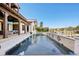 Exterior view of the pool and patio with a spa, water features, and canal view at 801 Brightwaters Ne Blvd, St Petersburg, FL 33704