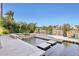 View of the pool and spa, with sitting ledges and waterfront views at 801 Brightwaters Ne Blvd, St Petersburg, FL 33704