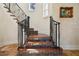 Detailed staircase with colorful decorative tile risers and dark iron railing at 801 Brightwaters Ne Blvd, St Petersburg, FL 33704