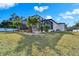 Expansive backyard with a screened pool, manicured lawn, and mature landscaping for privacy and enjoyment at 9401 93Rd St, Seminole, FL 33777