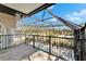 Screened in balcony with wrought iron railing overlooking the pool and backyard at 9401 93Rd St, Seminole, FL 33777