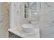 Modern bathroom featuring decorative sink, marble countertop, and tiled walls at 9401 93Rd St, Seminole, FL 33777
