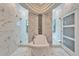 An elegant bathroom showcasing a freestanding tub and separate glass-enclosed showers at 9401 93Rd St, Seminole, FL 33777