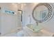 Stylish bathroom featuring a glass shower, decorative mirror, glass vessel sink, and modern fixtures at 9401 93Rd St, Seminole, FL 33777