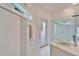 Bright bathroom with glass shower, decorative tiles, glass vessel sink, and natural light at 9401 93Rd St, Seminole, FL 33777