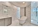 Upscale bath with marble tiling, a unique vessel sink, and glass enclosed shower with multiple shower heads at 9401 93Rd St, Seminole, FL 33777
