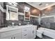 Modern bathroom with dual vessel sinks, sleek mirrors, and a luxurious shower-tub combination with rainfall shower at 9401 93Rd St, Seminole, FL 33777