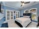 Stylish bedroom with a plush bed, crown molding, arched windows and unique glass doors with basketball hoops at 9401 93Rd St, Seminole, FL 33777