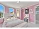 Charming pink bedroom with stylish decor, a vanity area, and bright windows at 9401 93Rd St, Seminole, FL 33777