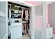 Organized closet with shelving, drawers, hanging rods, and fashionable handbags; perfect storage solution at 9401 93Rd St, Seminole, FL 33777