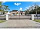 Elegant gated entrance to the property, with a private drive and manicured landscaping at 9401 93Rd St, Seminole, FL 33777