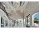 Grand foyer with decorative staircase, high ceilings, and chandelier lighting at 9401 93Rd St, Seminole, FL 33777