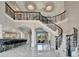 Grand foyer features soaring ceilings, elegant staircase, and marble floors leading to the living spaces at 9401 93Rd St, Seminole, FL 33777