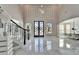 Elegant foyer with a soaring ceiling, marble floors, a decorative staircase, and a grand entry door at 9401 93Rd St, Seminole, FL 33777