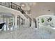 Elegant foyer with a winding staircase, marble floors, and views to the living and dining spaces at 9401 93Rd St, Seminole, FL 33777