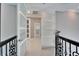 Bright hallway features white-trimmed doors with frosted glass panels and an ornate iron banister at 9401 93Rd St, Seminole, FL 33777