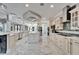 Bright, open kitchen with designer lighting, stainless appliances, and a center island at 9401 93Rd St, Seminole, FL 33777