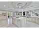 Gourmet kitchen island with marble countertop and stainless sink and gooseneck faucet at 9401 93Rd St, Seminole, FL 33777