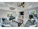 Spacious living room with decorative ceilings, ceiling fans, and comfortable sofas at 9401 93Rd St, Seminole, FL 33777