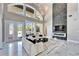 Bright living room with high ceilings, a fireplace, and views of the outdoor pool area at 9401 93Rd St, Seminole, FL 33777