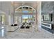 Elegant living room featuring high ceilings, large windows, fireplace, and designer furnishings at 9401 93Rd St, Seminole, FL 33777