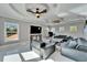 Spacious living room with decorative ceilings, ceiling fans, and large windows at 9401 93Rd St, Seminole, FL 33777