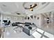 Spacious living room with decorative ceilings, ceiling fans, white floors at 9401 93Rd St, Seminole, FL 33777