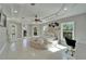 Bright bedroom features a round bed, light walls, unique fan, and windows with treed view at 9401 93Rd St, Seminole, FL 33777