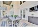 Outdoor patio featuring a dining table, seating, and TV, perfect for entertaining guests at 9401 93Rd St, Seminole, FL 33777