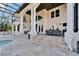 Elegant travertine patio with columns, outdoor dining area, and serene views of the backyard at 9401 93Rd St, Seminole, FL 33777