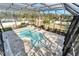 Aerial view of the kidney shaped pool and lounge area in screened in backyard at 9401 93Rd St, Seminole, FL 33777