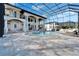 Screened pool area featuring a large pool, integrated spa, travertine tile, and covered outdoor kitchen at 9401 93Rd St, Seminole, FL 33777